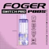 Blue sour raspberry pod from Foger with a transparent 19mL tank beside the Switch Pro charging dock