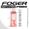 Cherry bomb Switch Pro pod by Foger with a clear 19mL tank beside the magnetic power bank dock