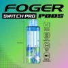Frozen wildberry mix pod by Foger clicked into the Switch Pro magnetic dock, clear 19mL tank showing the e-liquid level