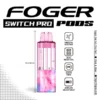 Pink and blue Switch Pro pod by Foger with a clear 19mL tank beside the magnetic charging dock