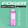 Skittles Cupcake Switch Pro pod with a clear 19mL tank and rainbow candy dessert flavor next to the Foger charging dock